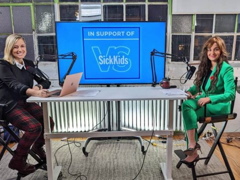 Fatima Zaidi and Amber Mac sitting at a table at the Tech4SickKids auction